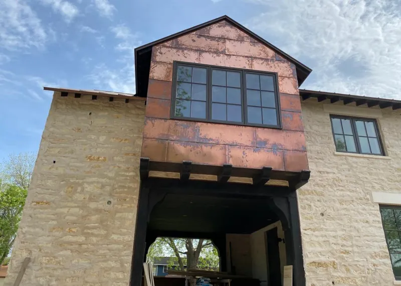 Copper metal panel facade on a stone building for Skylight Installation in Gadsden
