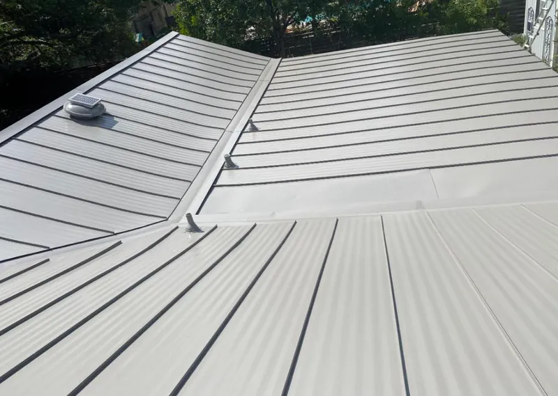Solar attic fan installed on a metal roof for Roof Ventilation in Gadsden